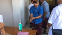 KPU Badung PARA anggota PPS wajib membersihkan tangan dengan cairan sanitasi tangan sebelum masuk ruangan pelantikan. Ini sebagai pelaksanaan protokol keamanan untuk mencegah penyebaran wabah Covid-19. Foto: gus hendra