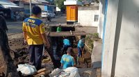 petugas membersihkan drainase
